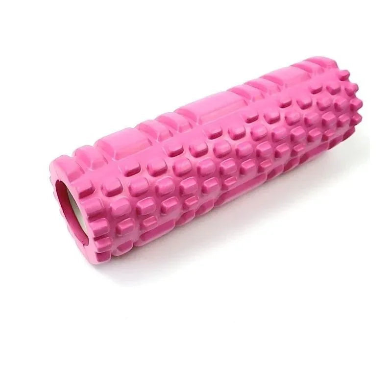 Pink foam roller with textured surface on a white background